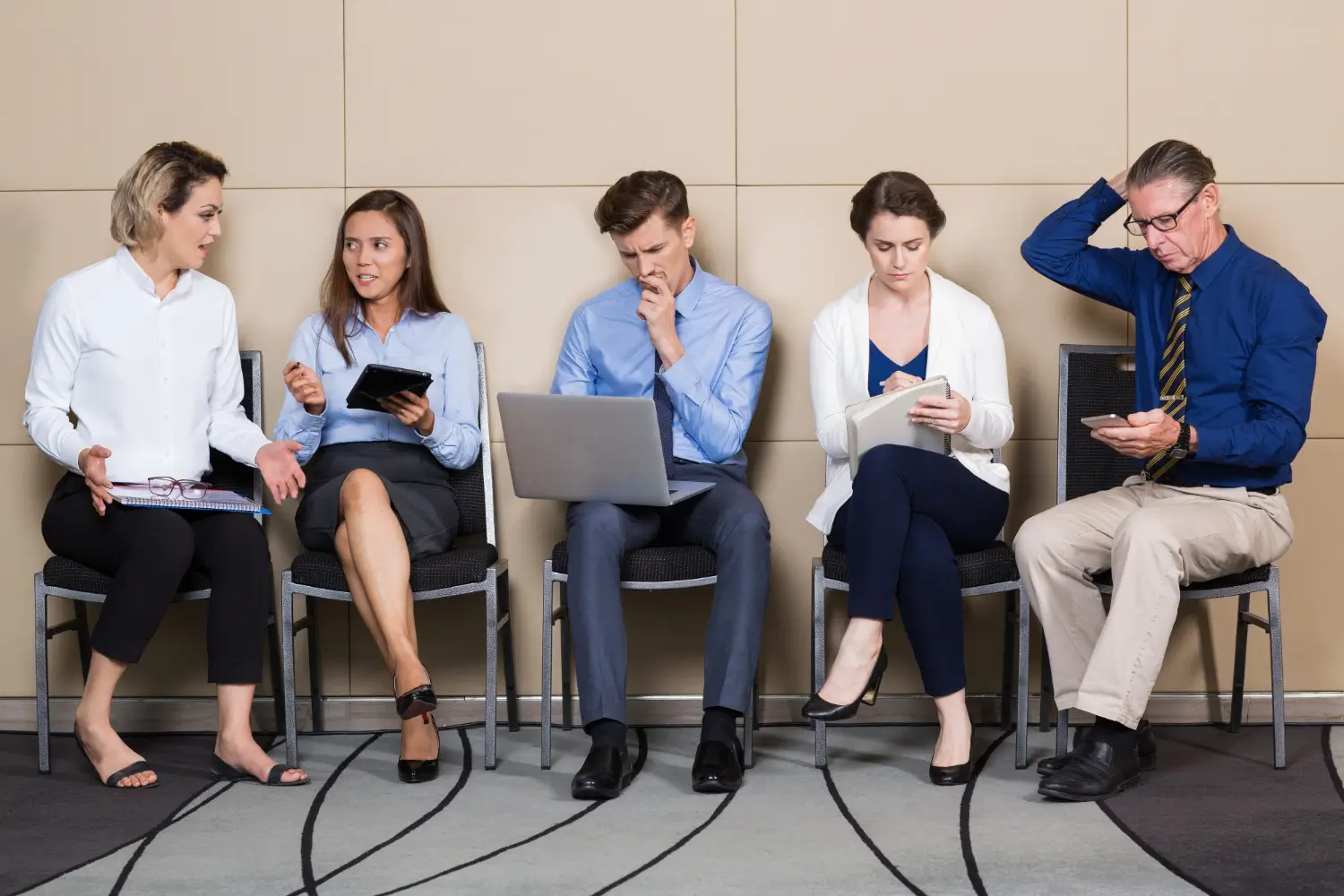 Job candidates sitting together waiting for an interview